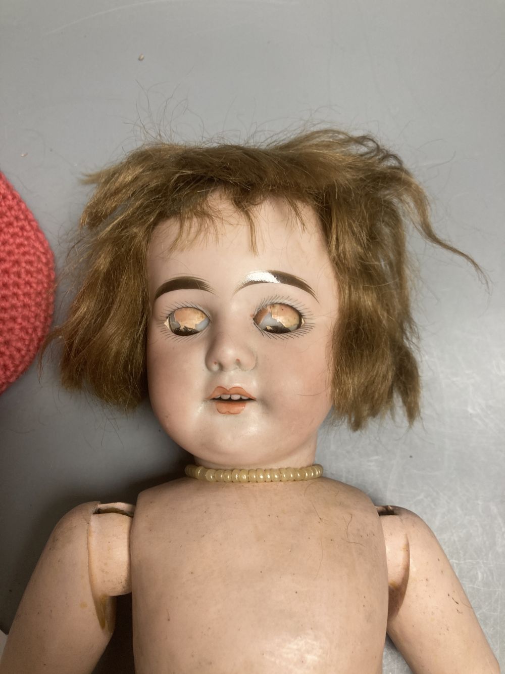 An Armand Marseille bisque boy doll, mould 990 with fixed glass eyes, 30cm, a bisque doll with jointed composition body, 47cm and a pai